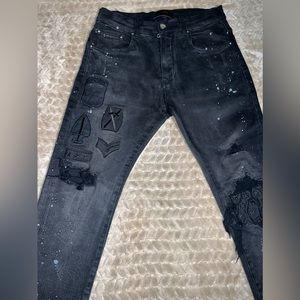 Very classic Black Amiri jeans with military patches and splatter paint.